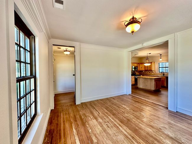 Unfurnished living room with hardwood / wood-style flooring and ornamental molding | Image 4