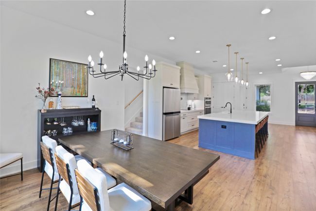 Dining space with light wood-type flooring, recessed lighting, and a chandelier | Image 15