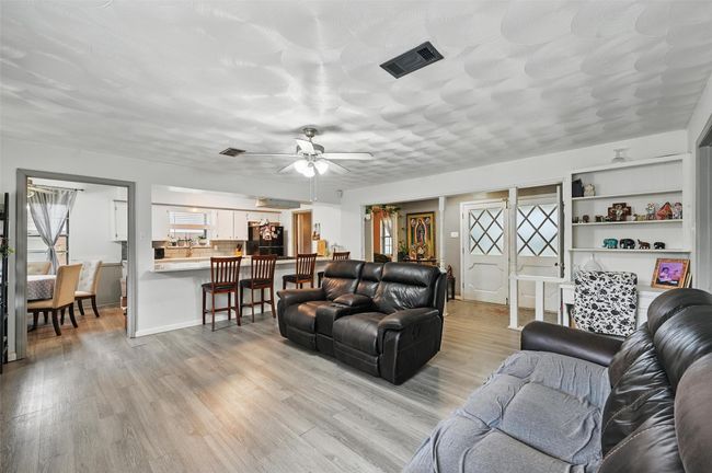 Living area featuring light wood-style floors and a ceiling fan | Image 9