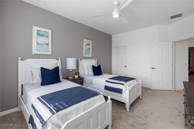 Bedroom with visible vents, ceiling fan, light carpet, and baseboards | Image 29