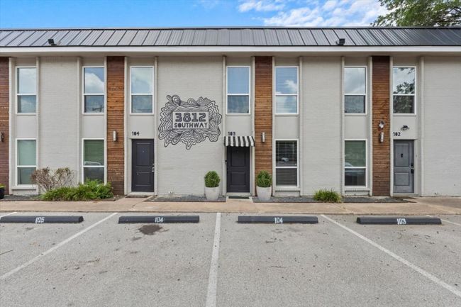 View of building exterior featuring uncovered parking | Image 6