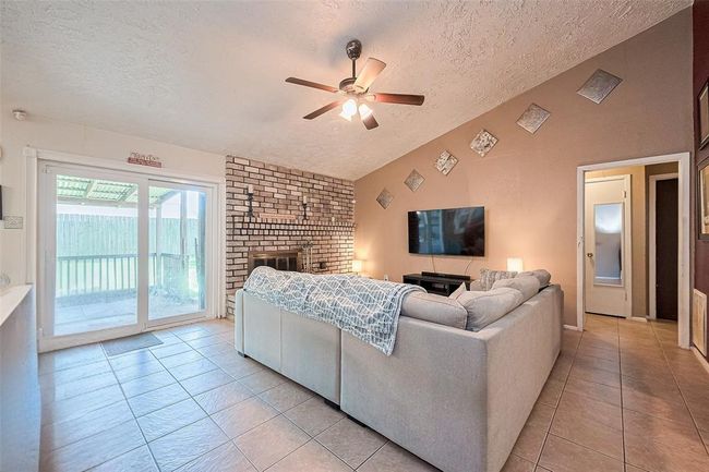 Adjacent view of spacious living room area big enough for a sectional couch with plenty of walking room. | Image 7