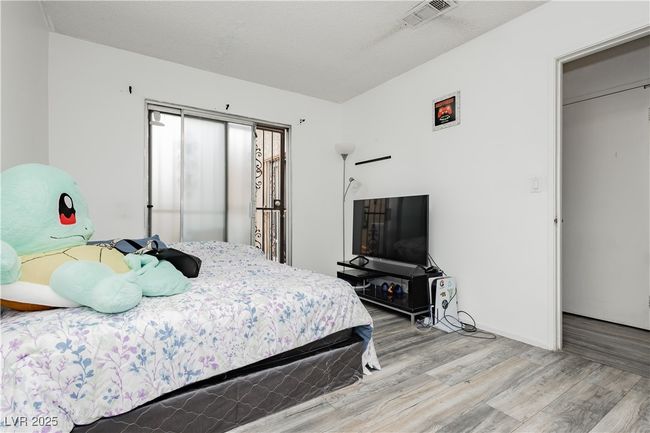 Bedroom featuring wood finished floors | Image 14