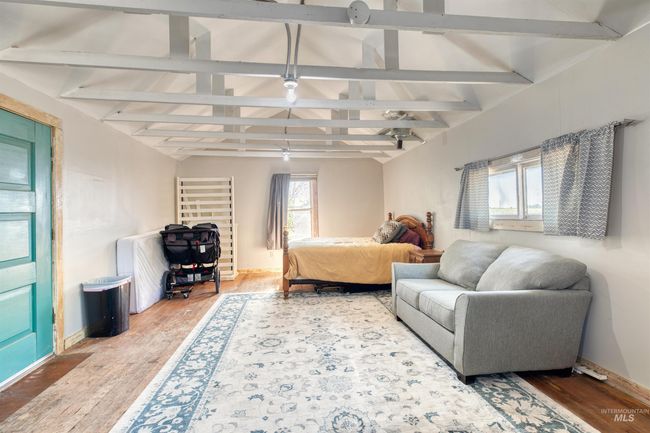 Bedroom with wood finished floors and baseboards | Image 39