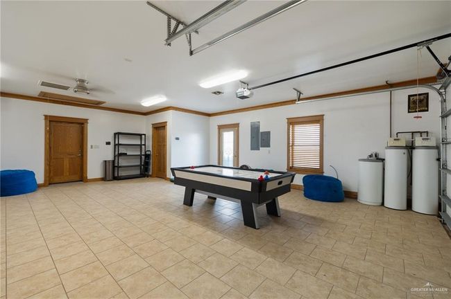 Rec room featuring electric panel, ceiling fan, and ornamental molding | Image 9