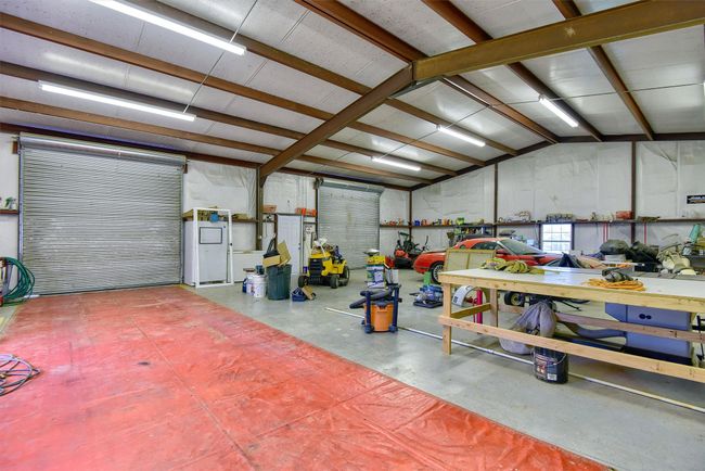 Garage with a workshop area | Image 37