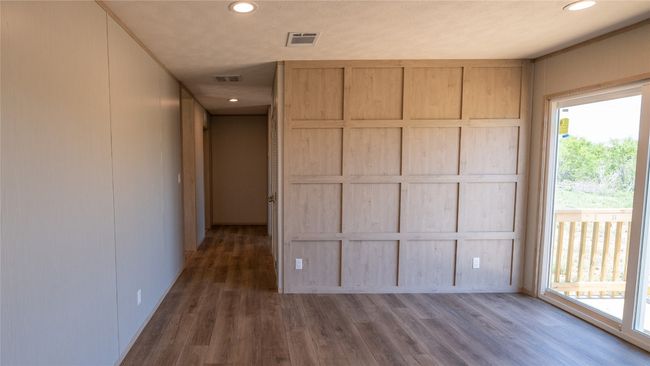 Unfurnished bedroom featuring wood finished floors, recessed lighting, and a decorative wall | Image 33