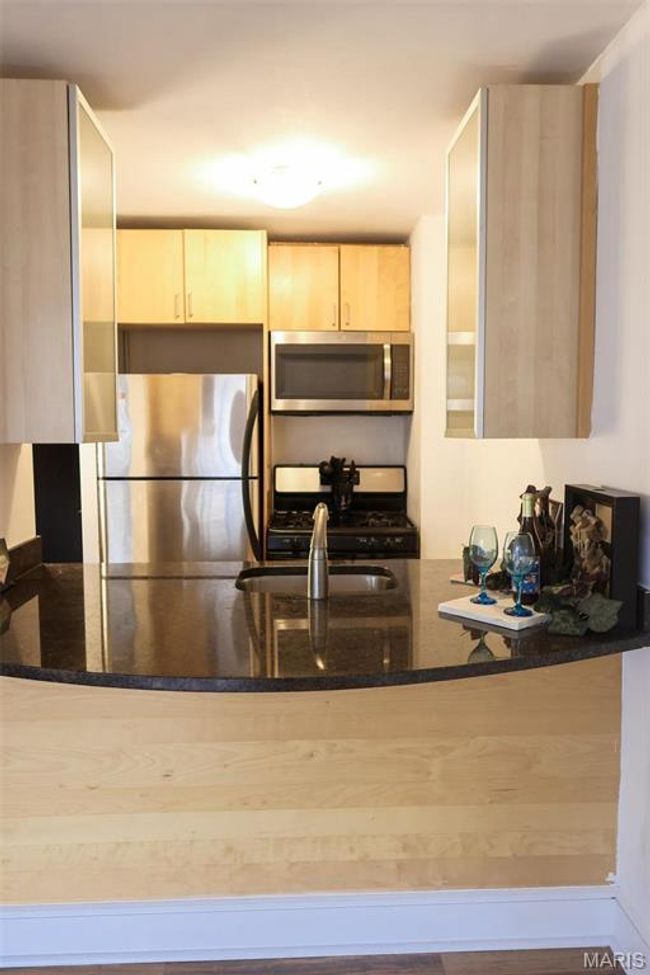 The kitchen features birch IKEA cabinets, granite counter tops, and stainless steel appliances. | Image 6