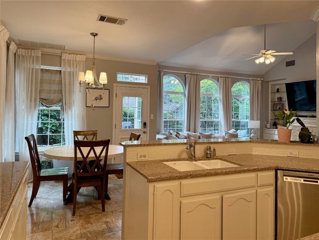 Kitchen featuring a sink, a wealth of natural light, visible vents, and dishwasher | Image 11