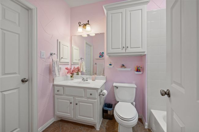 Bathroom featuring vanity, tile patterned floors, and shower / washtub combination | Image 35