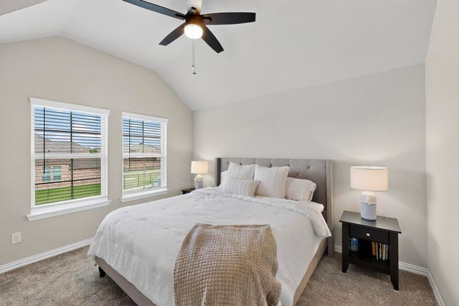 Bedroom with lofted ceiling, carpet flooring, and ceiling fan | Image 23