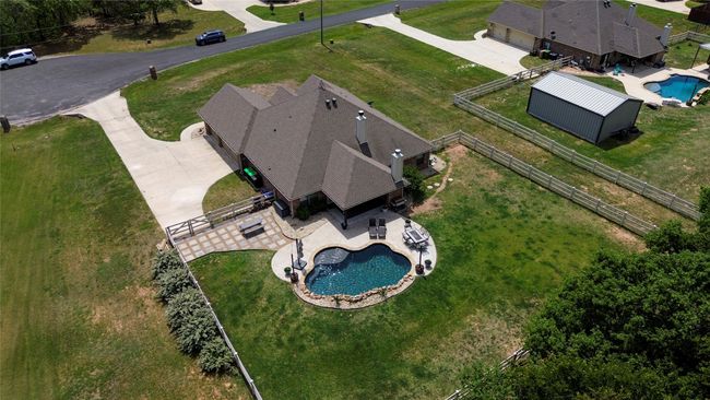 Backyard is fenced in...then beyond the white fence, is more of the property full of mature trees. | Image 5