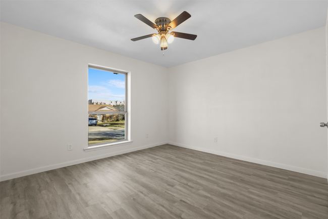 Empty room featuring ceiling fan and wood-type flooring | Image 9