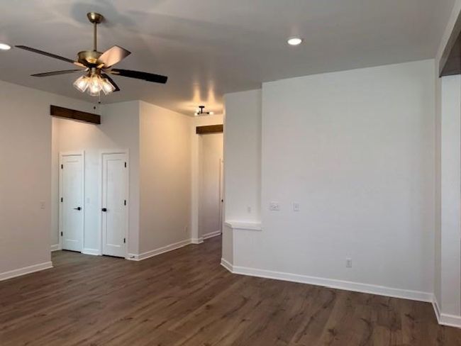 Empty room featuring dark wood finished floors, recessed lighting, a ceiling fan, and baseboards | Image 6