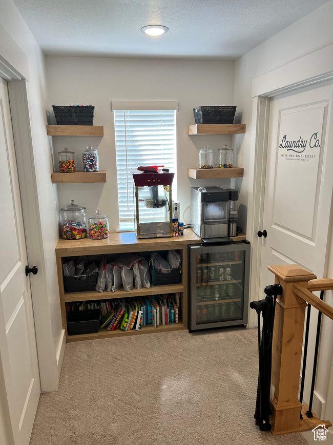 Sitting room with beverage cooler and carpet floors | Image 20