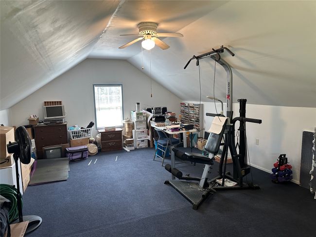 Workout room featuring ceiling fan and lofted ceiling | Image 49