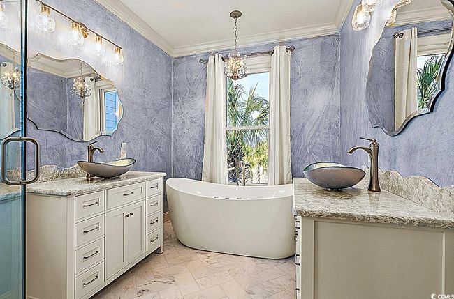 Full bath featuring marble finish floor, a sink, and crown molding | Image 26