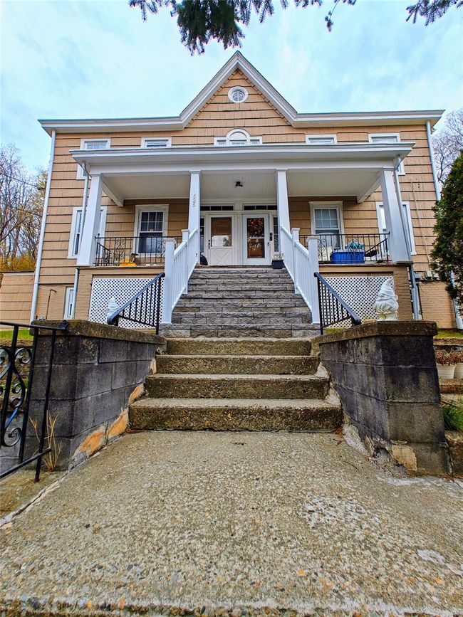 View of side of property with fence, roof with shingles, a chimney, and a yard | Image 11