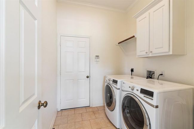 Convenient first-floor laundry room for easy everyday access. | Image 21