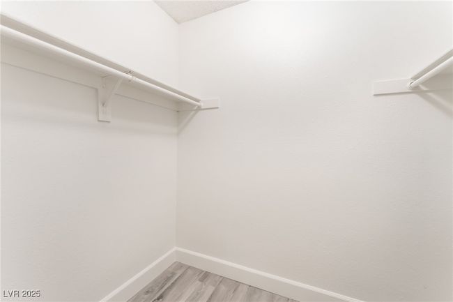 Spacious closet with light wood finished floors | Image 23