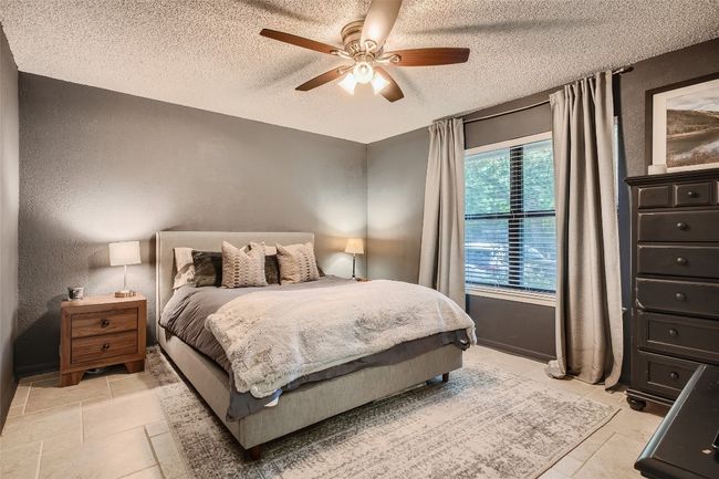Bedroom with a textured ceiling, a textured wall, and ceiling fan | Image 10