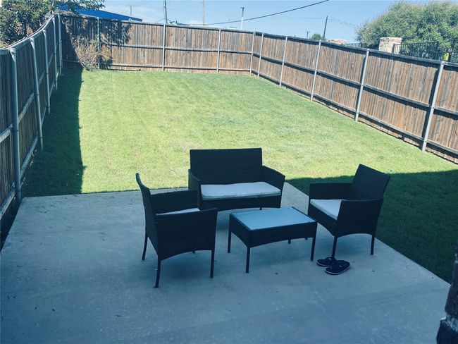 Fenced backyard with a patio area and outdoor lounge area | Image 26