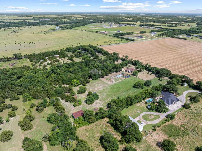 Aerial view of property's location with rural landscape and rows of crops | Image 12