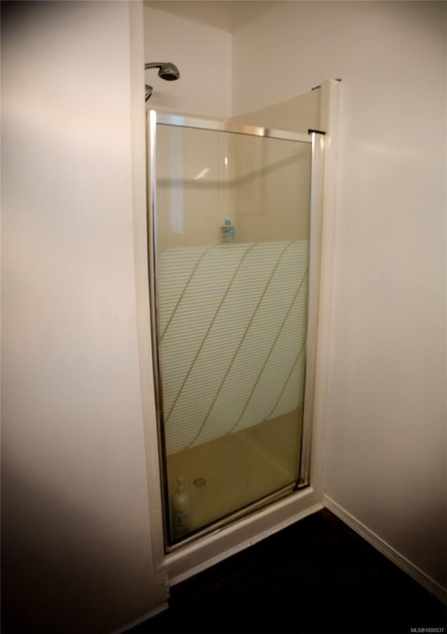 Laundry area with dark wood-style flooring and washing machine and clothes dryer | Image 29