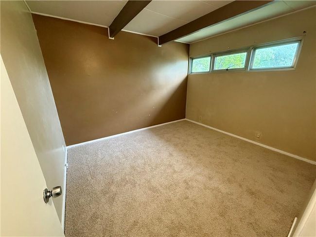 Unfurnished room with beam ceiling, baseboards, and carpet flooring | Image 11