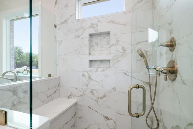 Full bath featuring a marble finish shower | Image 31