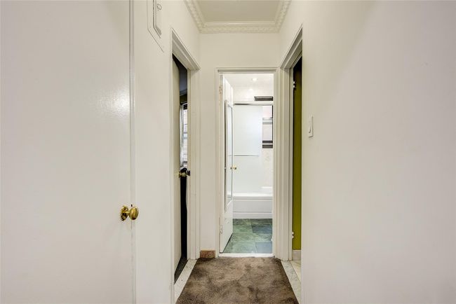 Hallway with ornamental molding and light carpet | Image 16