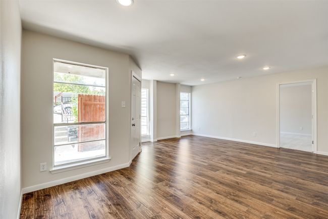 Unfurnished room featuring plenty of natural light and dark hardwood / wood-style flooring | Image 8