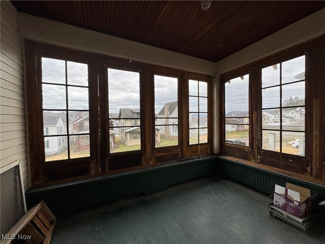 Unfurnished sunroom featuring a residential view | Image 9