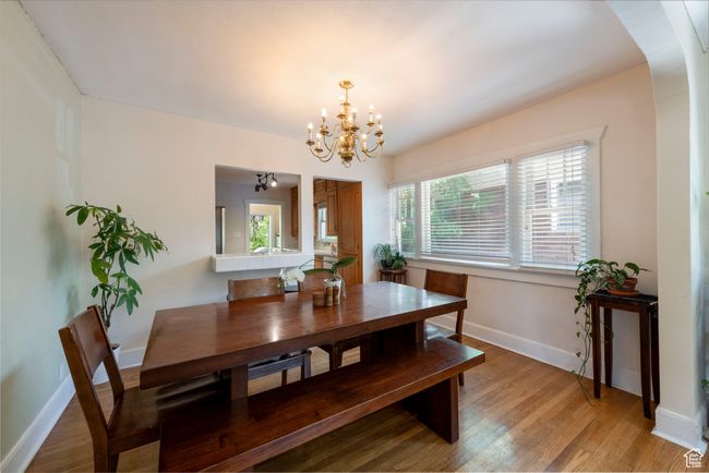 Dining space with a chandelier and light wood finished floors | Image 8