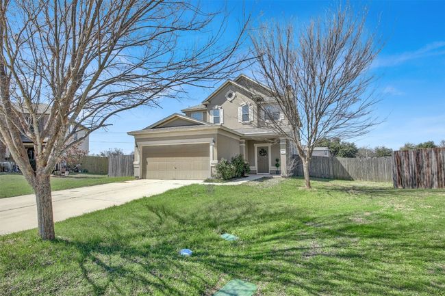 View of front of house featuring driveway, a front lawn, a chimney, and fence | Image 5