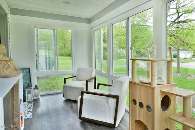 Sunroom / solarium with healthy amount of natural light and wood finished floors | Image 42