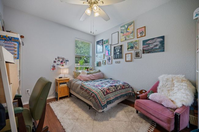 Bedroom featuring wood finished floors, a ceiling fan, and baseboards | Image 19