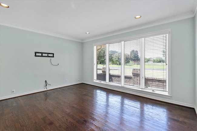 Unfurnished room featuring ornamental molding, dark hardwood / wood-style flooring, and a wealth of natural light | Image 14