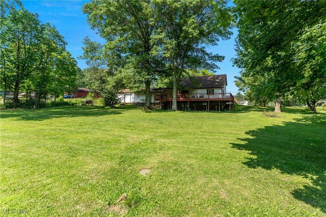 View of grassy yard with a deck | Image 41