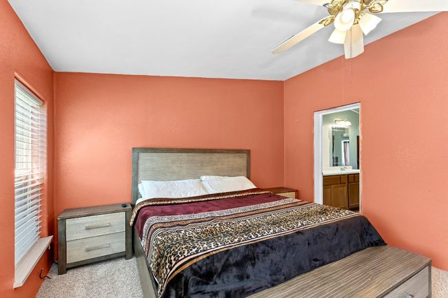 Bedroom with carpet, ceiling fan, and connected bathroom | Image 14