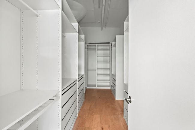 Walk in closet featuring light wood-style floors | Image 31