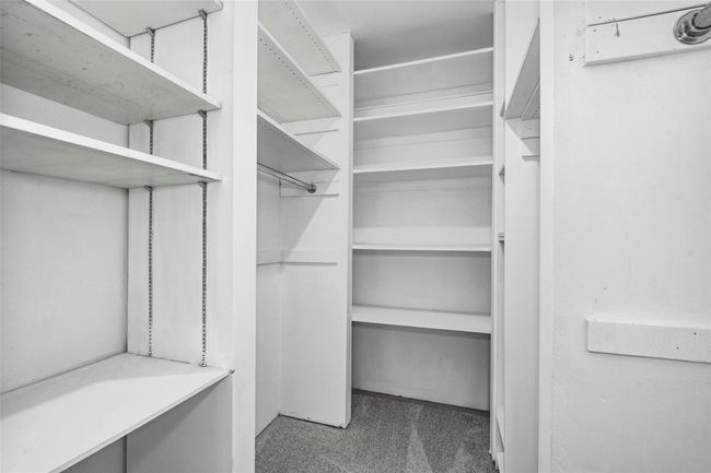 Walk in closet with carpet floors | Image 14