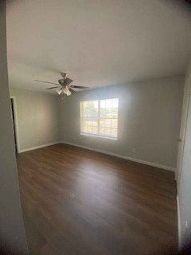 Unfurnished room featuring wood finished floors, a ceiling fan, and baseboards | Image 27