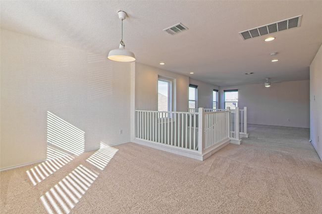 Hall with carpet floors, recessed lighting, and an upstairs landing | Image 23