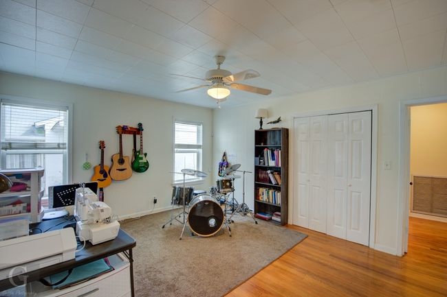 Office featuring a ceiling fan, light wood-type flooring, visible vents, and baseboards | Image 25