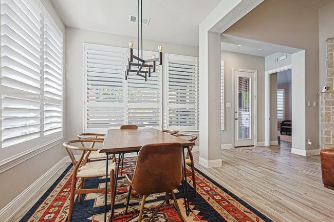 Breakfast nook with great view of the tree lined backyard. | Image 10