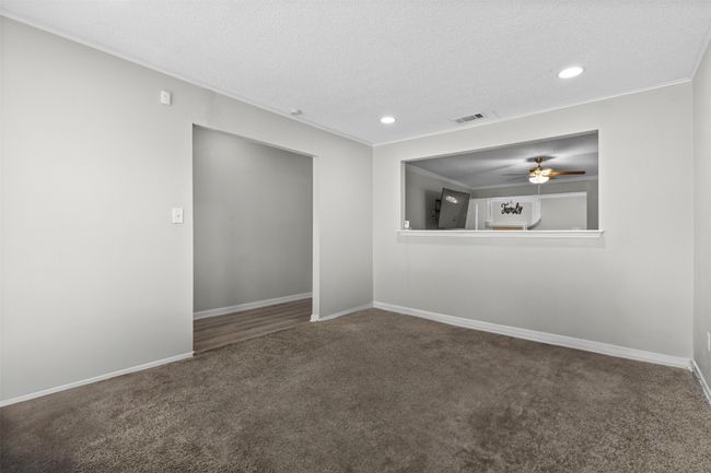 Carpeted spare room with ceiling fan, a textured ceiling, visible vents, baseboards, and recessed lighting | Image 4