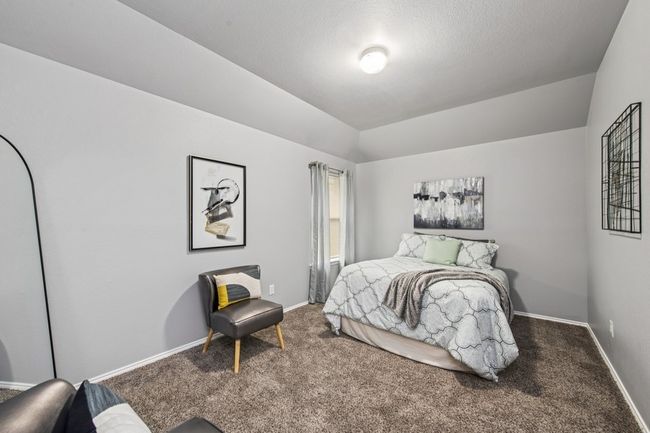 Carpeted bedroom with baseboards and lofted ceiling | Image 35