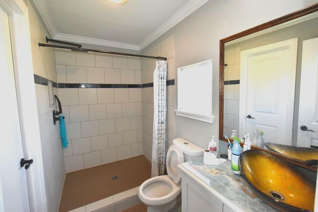 Luxurious primary bathroom with modern fixtures and a serene atmosphere. | Image 14