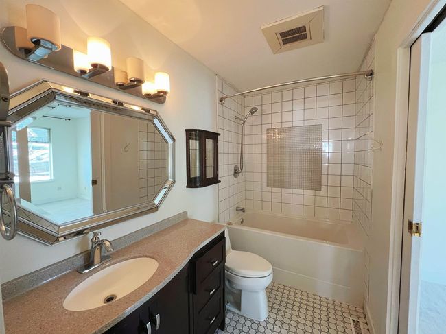 Bathroom featuring vanity, shower / bath combination, and tile patterned floors | Image 12